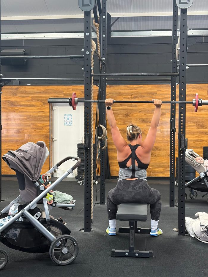 Buggy Fit at Motion CrossFit GU1, pressing a barbell overhead